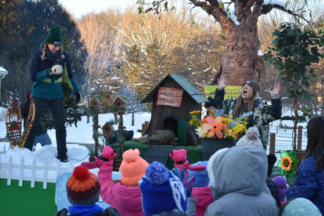 The crowd celebrates as Woody stays out of her house, meaning spring is coming soon.