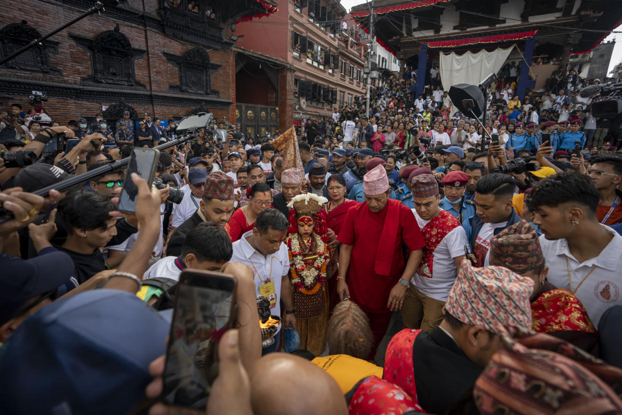 Living goddess Kumari is directed towards a chariot during Indra Jatra, a festival that marks the end of the rainy season in Kathmandu, Nepal, Tuesday, Sept. 17, 2024. (AP Photo/Niranjan Shrestha)