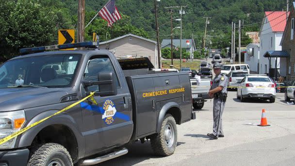 PHOTO: KKentucky State Police officers block off a street in Allen, a small town in Floyd County, Kentucky, July 1, 2022, as the investigation continues into a shooting in which three police officers were killed. (Lexington Herald-Leader/Tribune News Service via Getty Images)