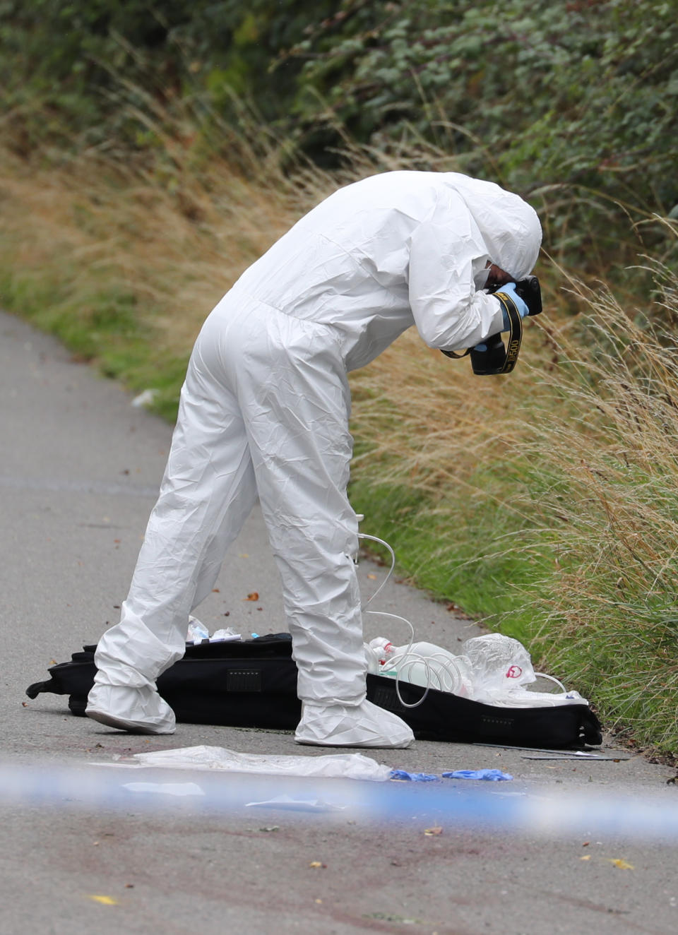 A police investigator at the scene of an incident, near Sulhamstead, Berkshire, where a Thames Valley Police officer was killed whilst attending a reported burglary on Thursday evening.