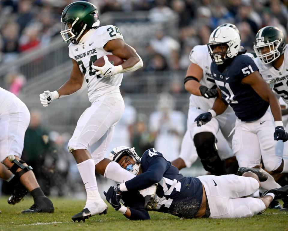 Penn State defensive end Chop Robinson trips up Michigan State’s Elijah Collins during the game on Saturday, Nov. 26, 2022.