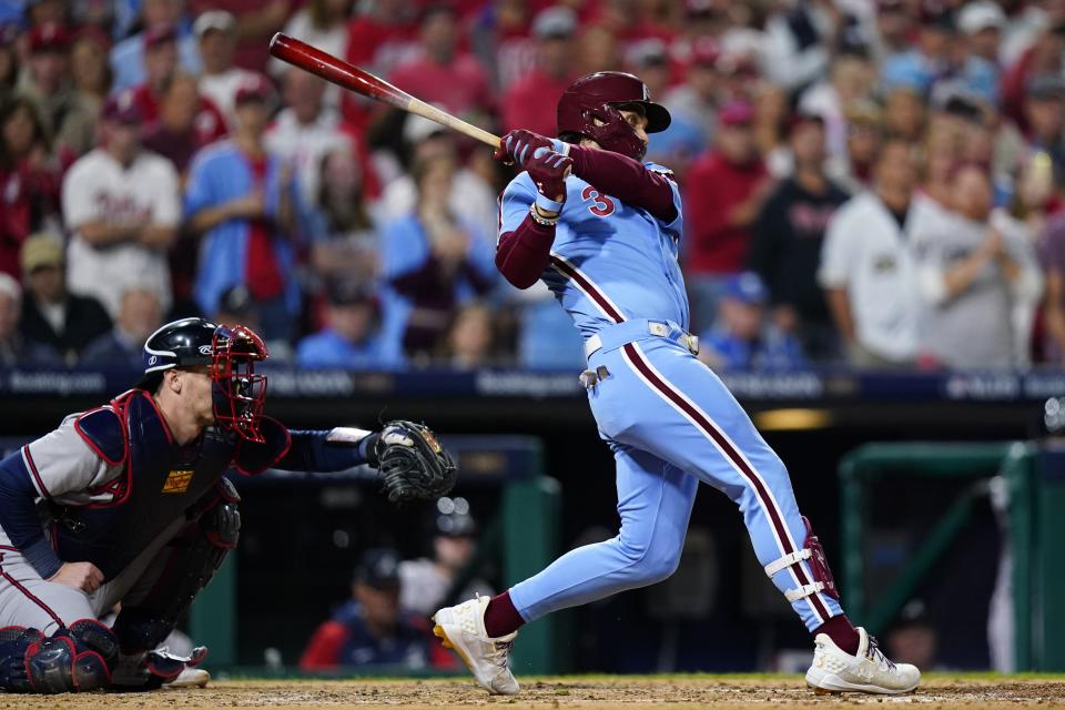 Philadelphia Phillies' Bryce Harper hits a single during the third inning of Game 4 of a baseball NL Division Series against the Atlanta Braves Thursday, Oct. 12, 2023, in Philadelphia. (AP Photo/Chris Szagola)