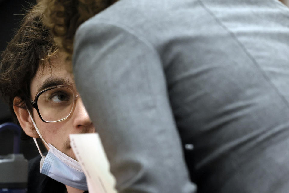 Marjory Stoneman Douglas High School shooter Nikolas Cruz speaks with Assistant Public Defender Tamara Curtis as the court takes a recess during jury selection in the penalty phase of his trial at the Broward County Courthouse in Fort Lauderdale on Monday, June 6, 2022. Cruz previously plead guilty to all 17 counts of premeditated murder and 17 counts of attempted murder in the 2018 shootings. (Amy Beth Bennett/South Florida Sun Sentinel via AP, Pool)