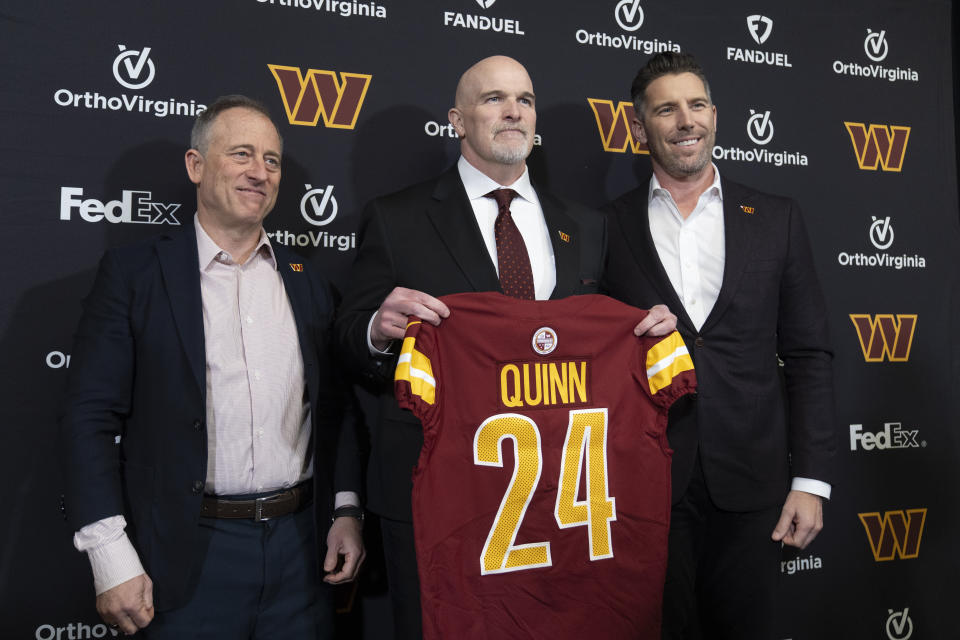 Washington Commanders new head coach Dan Quinn, center, holds a jersey as he stands with Commanders managing partner Josh Harris, left, and general manager Adam Peters, right, during an NFL football news conference at Commanders Park in Ashburn, Va., Monday, Feb. 5, 2024. (AP Photo/Manuel Balce Ceneta)