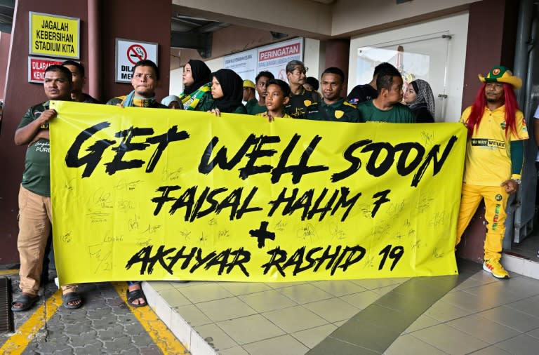 Fans hold a banner supporting injured footballers before the start of the Malaysia Super League match between Polis DiRaja Malaysia (PDRM) FC and Kedah (Mohd RASFAN)