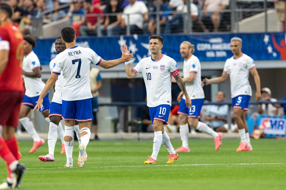 Gio Reyna and Christian Pulisic high five during their win over Bolivia. (Matthew Visinsky/Icon Sportswire via Getty Images)