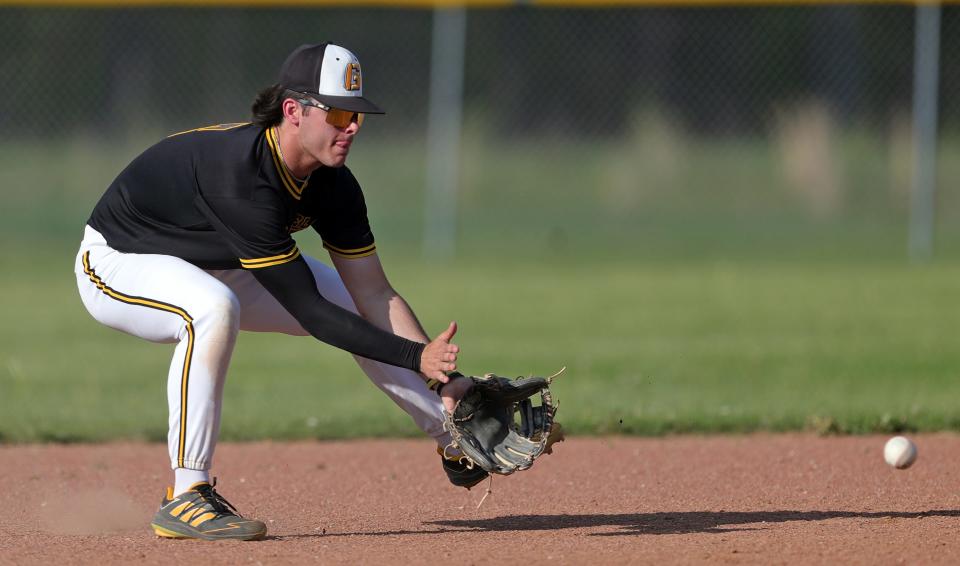 Garfield shortstop Eric Geddes looks to scoop up a ground ball hit by Mogadore batter Devin Graham during the third inning of a high school baseball game, Wednesday, May 1, 2024, in Garrettsville, Ohio.