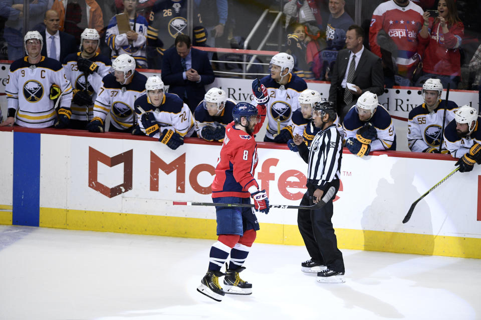 Washington Capitals left wing Alex Ovechkin (8), of Russia, celebrates his goal during a shootout of an NHL hockey game as he skates by the Buffalo Sabres bench, Saturday, Dec. 15, 2018, in Washington. (AP Photo/Nick Wass)