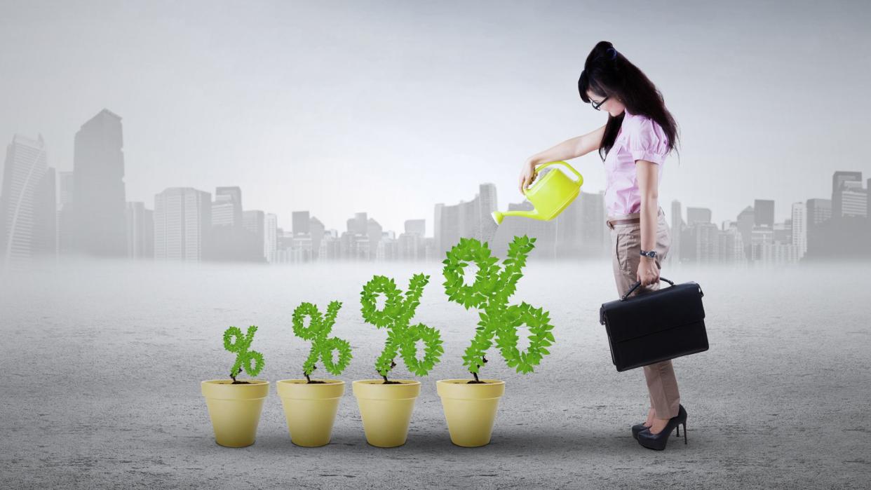 Image of successful young woman with plant on the pots shaped percentage symbol.