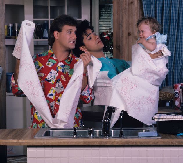 The scene from the pilot episode, in which Mary Kate or Ashely Olsen does indeed look displeased to be wrapped in paper towels and dangled over a kitchen sink.