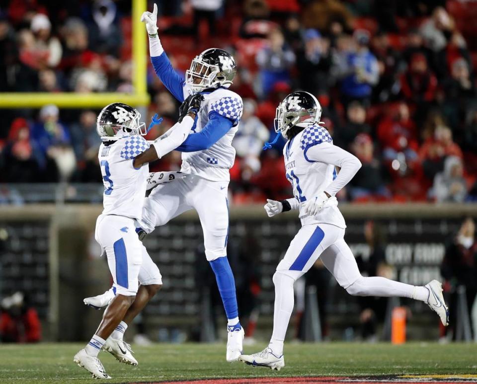 Kentucky’s Cedrick Dort Jr. (3), J.J. Weaver (13) and Quandre Mosely (21) celebrate an interception during the Wildcats’ Governor’s Cup victory over Louisville to end the regular season. UK will be back in action Jan. 1 in the Citrus Bowl at Orlando, Fla.