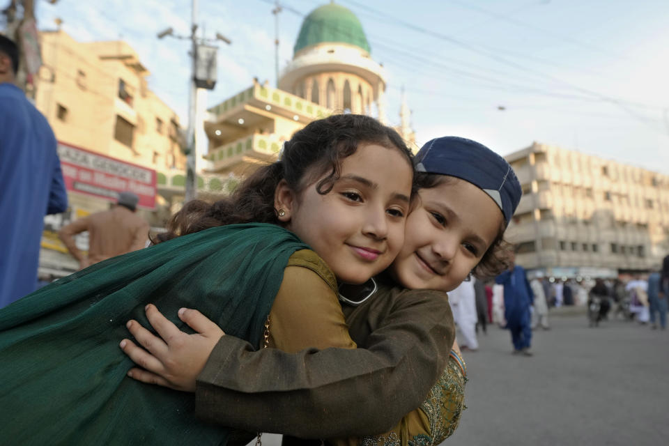 Muslim children share Eid greeting after attending an Eid al-Fitr prayer, marking the end of the fasting month of Ramadan in Karachi, Pakistan, Wednesday, April, 10, 2024. (AP Photo/Fareed Khan)