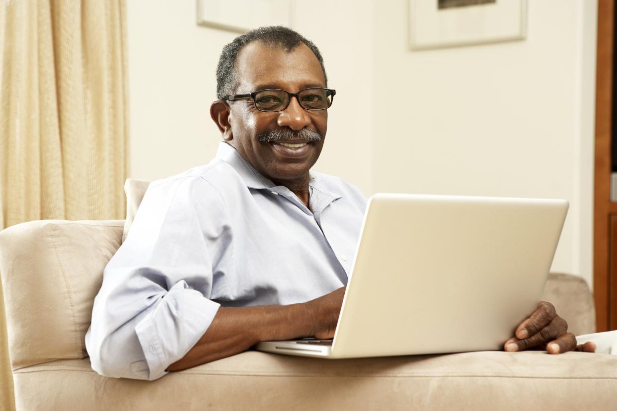 senior man using laptop at home