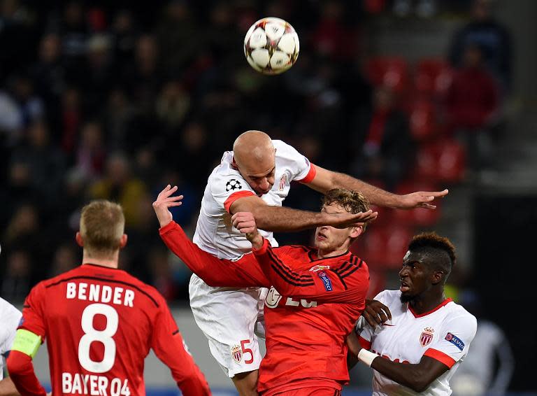 Leverkusen's striker Stefan Kiessling, Monaco's Aymen Abdennour and Tiemuoe Bakayoko vie for the ball during their UEFA Champions League second leg Group C football match in Leverkusen, Germany, on November 26, 2014