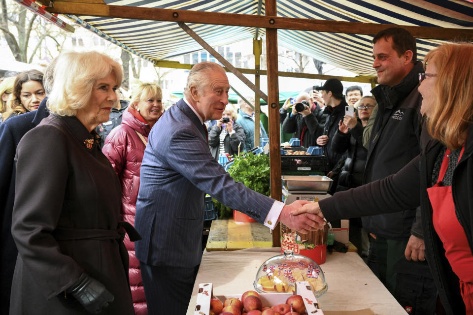 Britain's King Charles and Camilla, the Queen Consort visit a farmer's market on Wittenbergplatz square, in Berlin, Germany, Thursday, March 30, 2023. (Annegret Hilse//Pool Photo via AP)