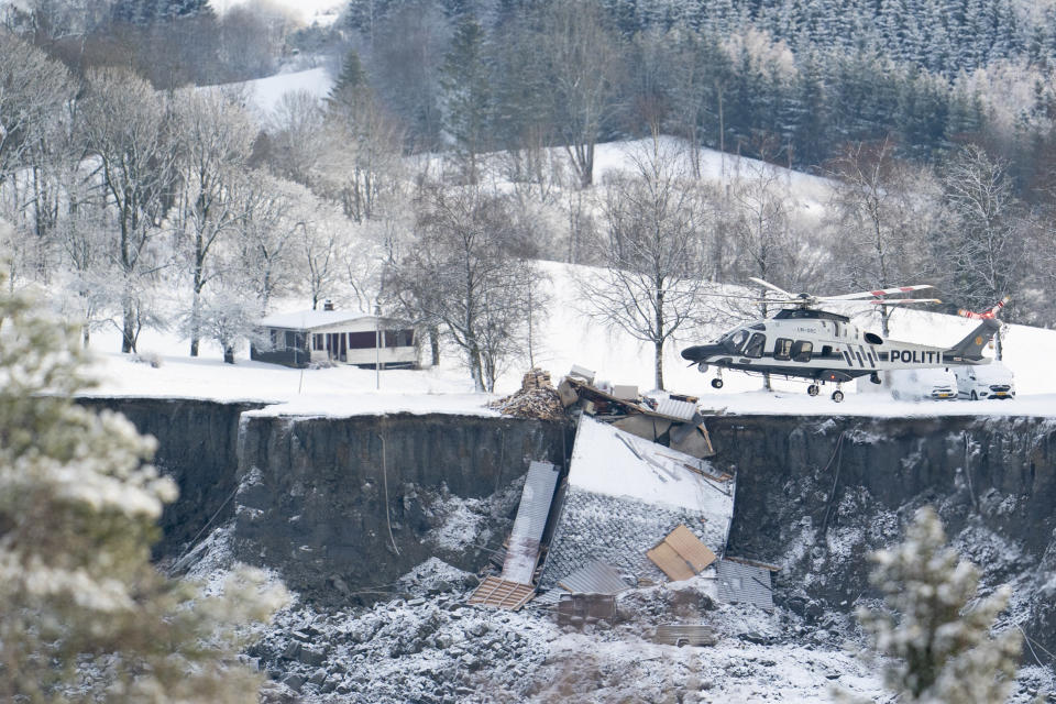 Emergency services near the site of a landslide in Ask, northeast of Oslo, Thursday, Dec. 31, 2020. A landslide smashed into a residential area near the Norwegian capital Wednesday. (Fredrik Hagen/NTB via AP)