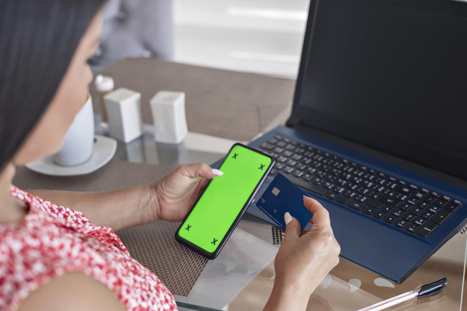 A woman looking at her credit card