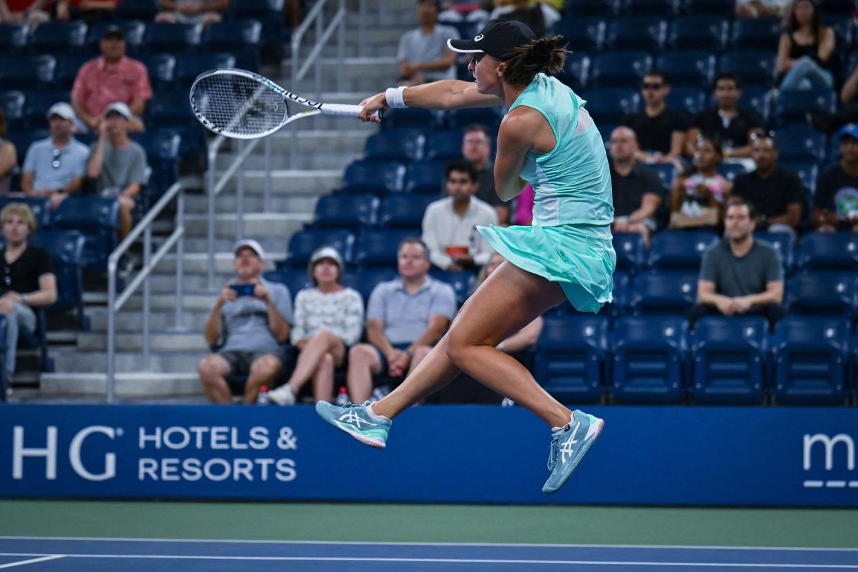 Poland's Iga Swiatek hits a return to USA's Lauren Davis during their 2022 U.S. Open Tennis tournament women's singles third round match at the USTA Billie Jean King National Tennis Center in New York on Sept. 3, 2022.