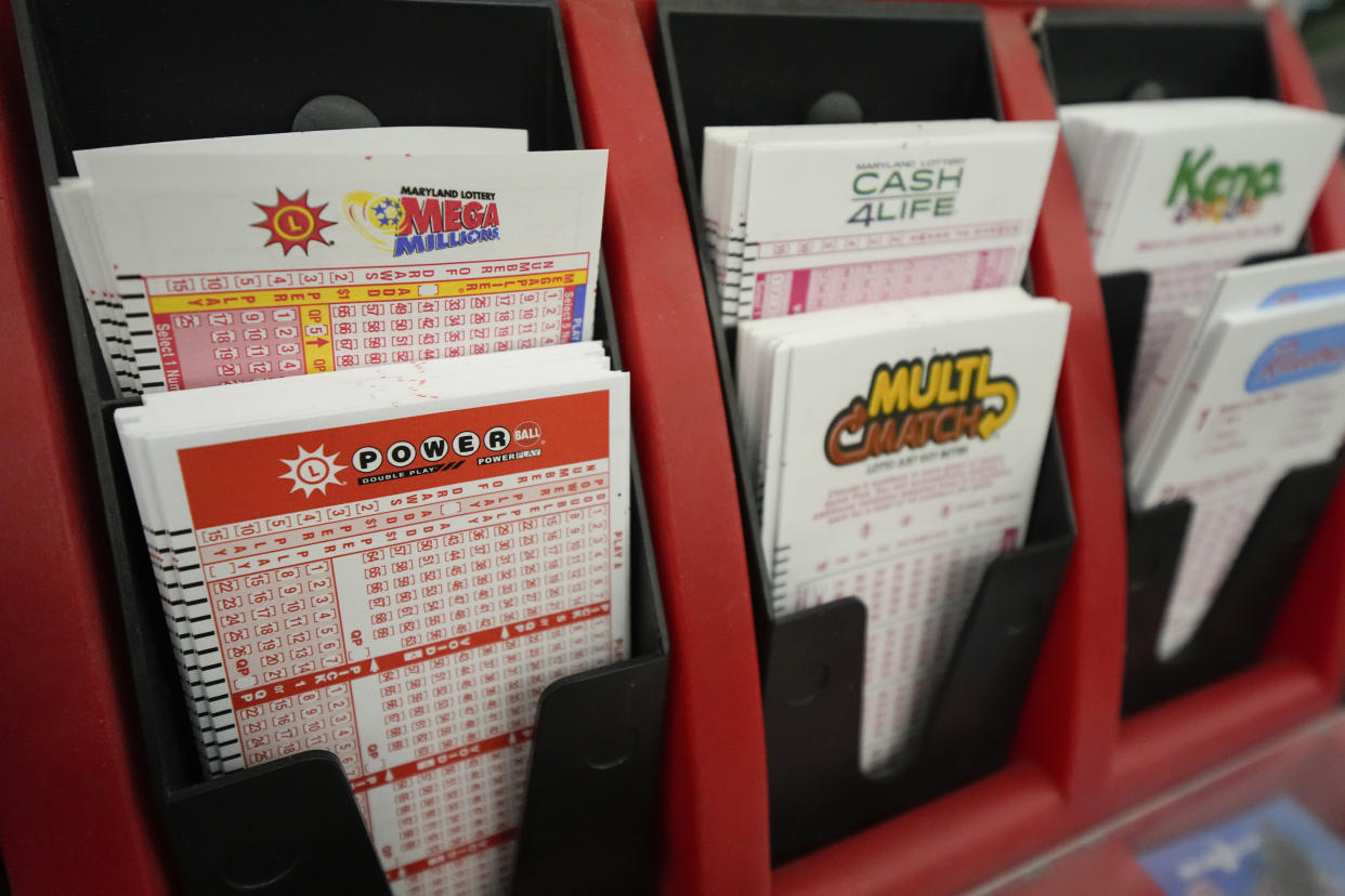 Play stubs are displayed at the lottery counter at Broad Street Liquors, Tuesday, Jan. 3, 2023, in Timonium, Md. An estimated $785 million Mega Millions jackpot set for Tuesday night will give lottery players a chance to start the new year with a lucrative bang. (AP Photo/Julio Cortez)