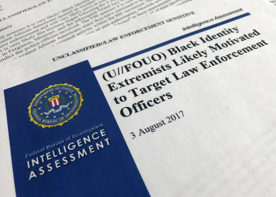 FILE - In this Nov. 17, 2017, file photo, the cover page of a FBI report on the rise of black "extremists" is photographed in Washington. The report is stirring fears of a return to practices of the Civil Rights era, when the agency notoriously spied on activist groups without evidence they had broken any laws. The American Civil Liberties Union and others are suing the FBI for records to find out more about a divisive 2017 report on the rise of black "extremists" following the shooting deaths of African-Americans. The FBI released an intelligence assessment in 2017 saying that "black identity extremists" were targeting law enforcement after police killings of black men. Critics say they fear the FBI is using the assessment to profile blacks who speak out against police violence. (AP Photo/Jon Elswick, File)