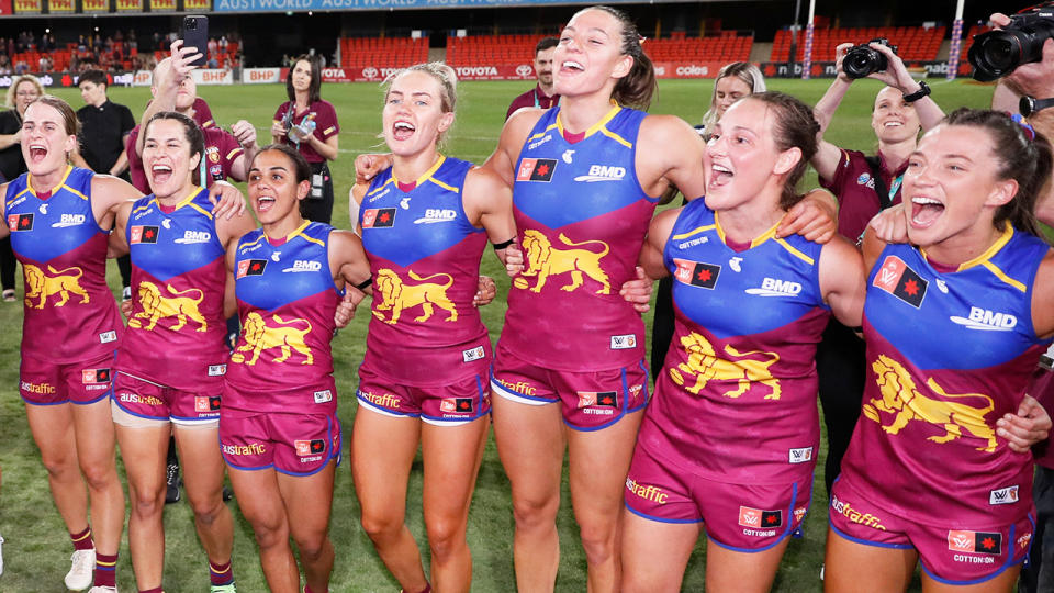 Brisbane Lions players, pictured here celebrating after advancing to the AFLW grand final.