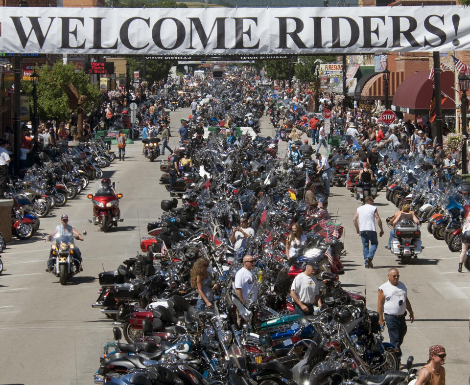 FILE - This Aug. 10, 2013 file photo shows motorcycle riders on Main Street in downtown Sturgis, S.D. Hundreds of thousands of bikers descend on the town of Sturgis, South Dakota (population: 6,600) every August for the annual Sturgis Rally gathering of motorcycle enthusiasts. This year’s rally is scheduled for Aug. 5-11 and anyone can attend. (AP Photo/Steve McEnroe, file)