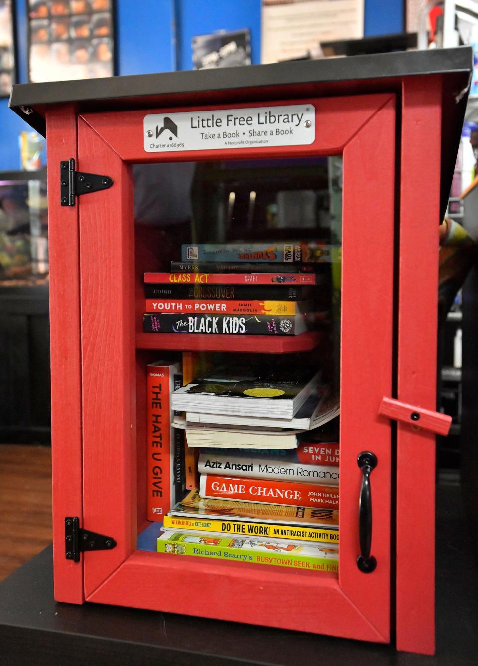 The Little Free Library box inside Cutz-Linez & Trimz barber shop on Moncrief Road showcases books from diverse authors, making them available at no charge. The box is the first outlet for the Unbanned Book Club, a Jacksonville-centered project to circulate books that have been banned or challenged at wchool systems.