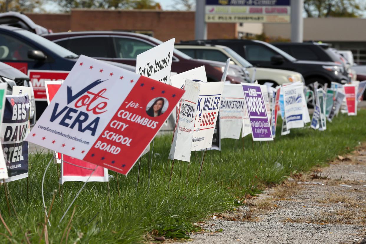 Campaign signs line the road leading in to the parking lot of the Franklin County Board of Elections during early voting Columbus, Ohio Nov. 1.