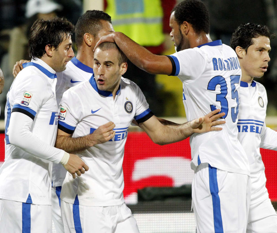 Inter Milan's Rodrigo Palacio, center, celebrates with teammates including Diego Milito, left, after scoring during a Serie A soccer match between Fiorentina and Inter Milan, at the Artemio Franchi stadium in Florence, Italy, Saturday, Feb. 15, 2014. (AP Photo/Fabrizio Giovannozzi)