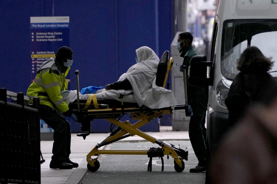 FILE - A patient is pushed on a trolley outside the Royal London Hospital in the Whitechapel area of east London, Thursday, Jan. 6, 2022. The omicron variant is exposing weaknesses at the heart of Europe's public health system. In France and Britain, a sharp rise in coronavirus hospitalizations coupled with staff falling sick has led to a shortage of beds. (AP Photo/Matt Dunham, File)