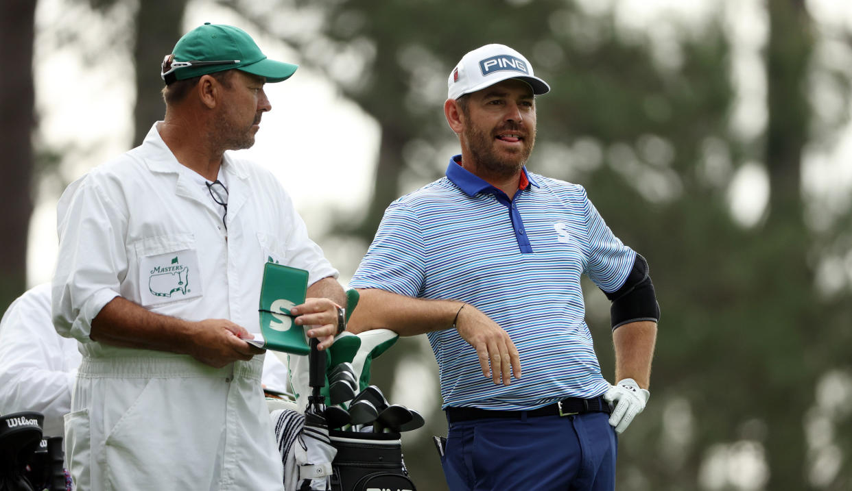  Oosthuizen stands by his caddie during the second round of The Masters 