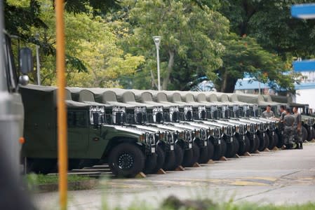 Troops are seen by a row of over a dozen army jeeps at the Shek Kong military base of People's Liberation Army (PLA)