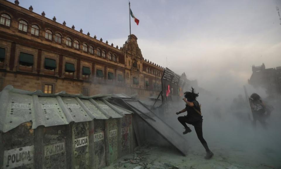 Activists clash with police during a protest against the alarming numbers of murders of women.