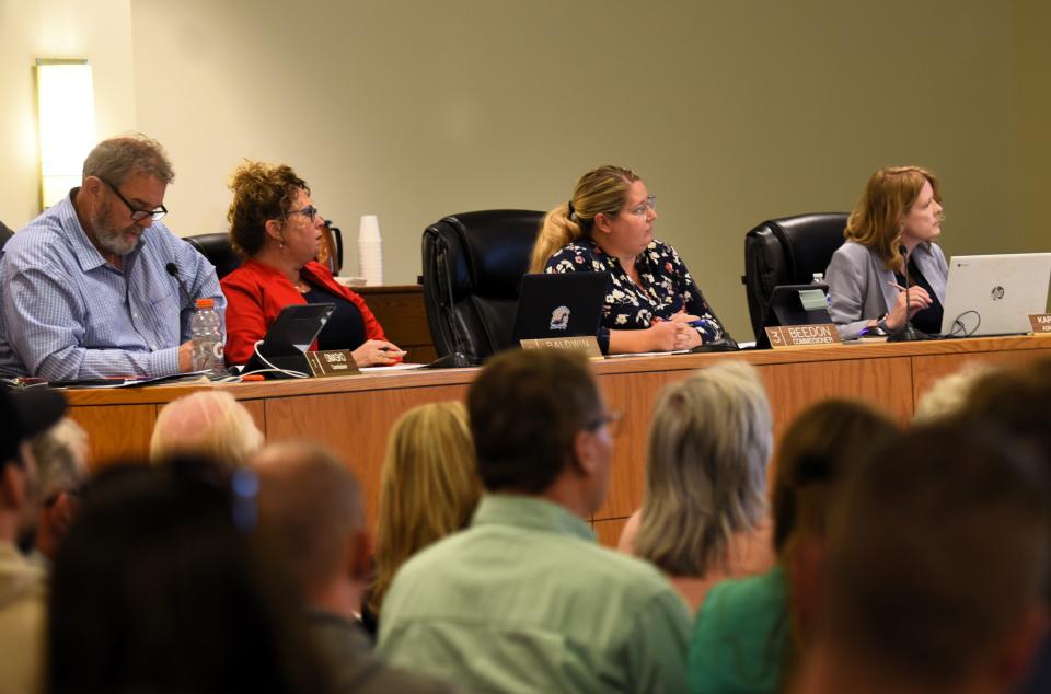 St. Clair County Commissioners Steve Simasko, from left, Jorja Baldwin, and Lisa Beedon, and County Administrator Karry Hepting, listen to board discussion during a meeting on Thursday, May 2, 2024, in Port Huron.