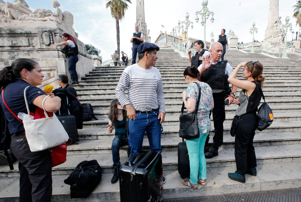 Police keep travellers at a distance as they secure the access to the Saint-Charles train station after French soldiers shot and killed a man who stabbed two women to death at the main train station in Marseille, France, October 1, 2017. REUTERS/Jean-Paul Pelissier