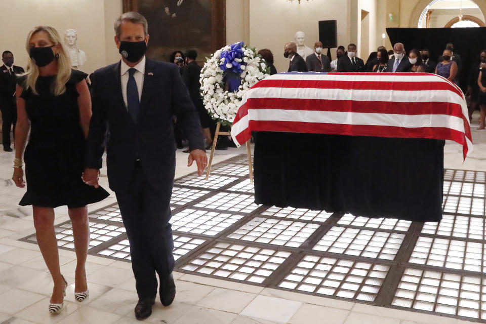 Gov. Brian Kemp and his wife Marty Kemp, leave the capital after a service for Rep. John Lewis lying in repose at the state capital, Wednesday, July 29, 2020, in Atlanta. Lewis, who carried the struggle against racial discrimination from Southern battlegrounds of the 1960s to the halls of Congress, died Friday, July 17, 2020. (AP Photo/John Bazemore)