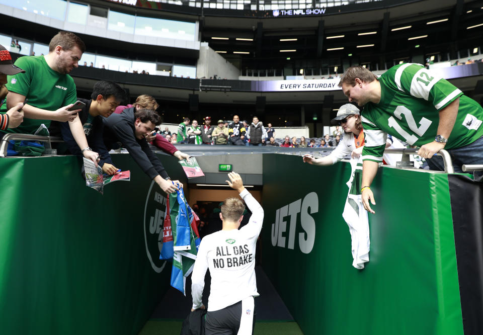 New York Jets quarterback Zach Wilson (2) leaves the field after the first warm-up before an NFL football game between the New York Jets and the Atlanta Falcons at the Tottenham Hotspur stadium in London, England, Sunday, Oct. 10, 2021. (AP Photo/Ian Walton)