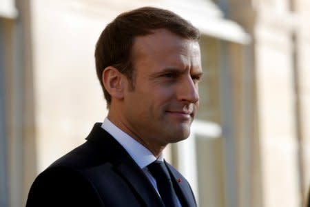 French President Emmanuel Macron welcomes guests for a lunch at the Elysee Palace as part of the One Planet Summit in Paris, France, December 12, 2017. REUTERS/Philippe Wojazer