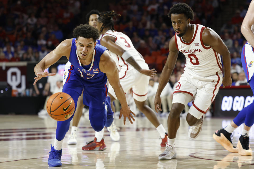 Kansas guard Kevin McCullar Jr., left, goes against Oklahoma guard Le'Tre Darthard (0) during the first half of an NCAA college basketball game Saturday, Feb. 17, 2024, in Norman, Okla. (AP Photo/Garett Fisbeck)