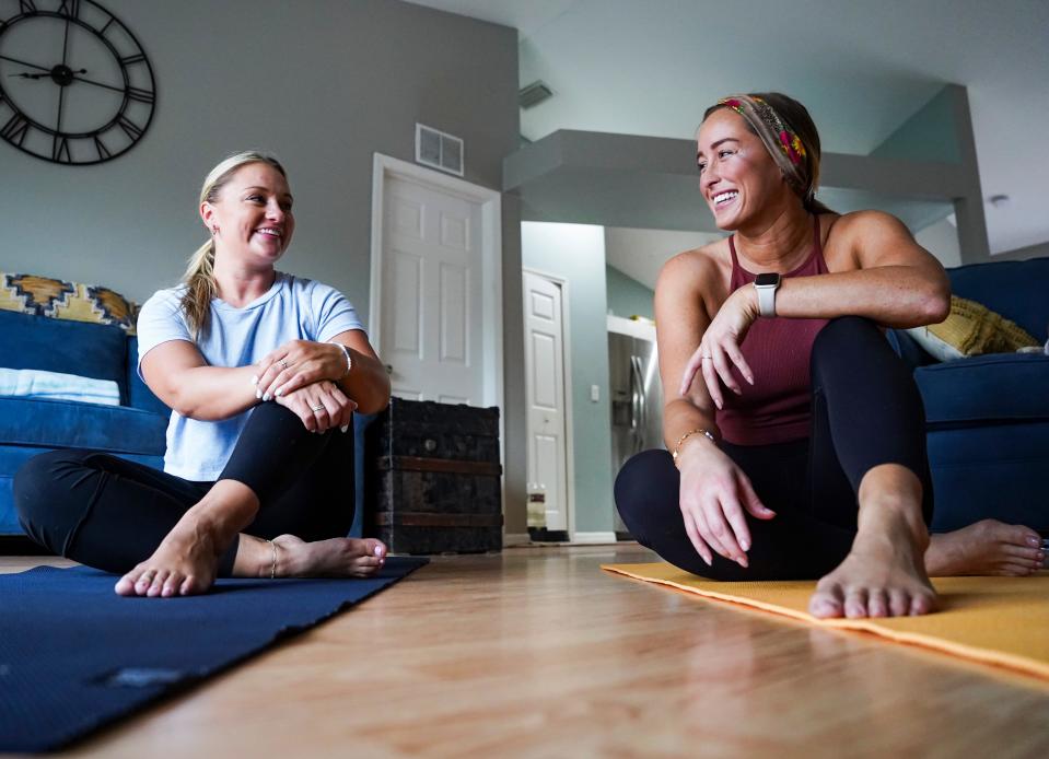 Patty Kulak, left, and Marissa Baker talk at their home in Naples on Sunday, June 25, 2023. The two became friends while supporting each other through their divorces and now live together in what they call a “platonic life partnership.”