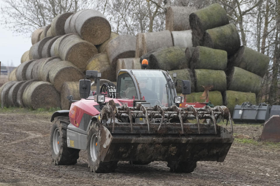 Piotr Korycki, a 34-year-old Polish farmer, drives farm equipment on his farm in Cywiny Wojskie, Poland, on Monday March 18, 2024. Piotr says his business has been badly destabilized by Russia’s war against Ukraine and that the European Union is only adding to his problems. He's among the large number of farmers who have protested across Europe for months, and he’s organizing the latest protest planned for Poland on Wednesday. (AP Photo/Czarek Sokolowski)