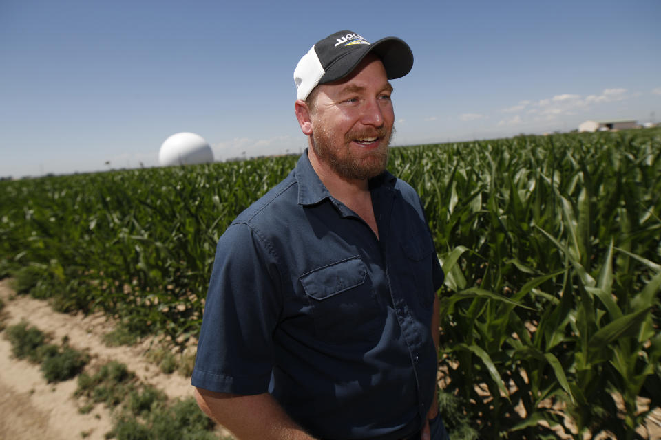 In this Thursday, July 11, 2019, photograph, Kendall DeJonge of the United States Department of Agriculture is shown at a research farm northeast of Greeley, Colo. Researchers are using drones carrying imaging cameras over the fields in conjunction with stationary sensors connected to the internet to chart the growth of crops in an effort to integrate new technology into the age-old skill of farming. (AP Photo/David Zalubowski)