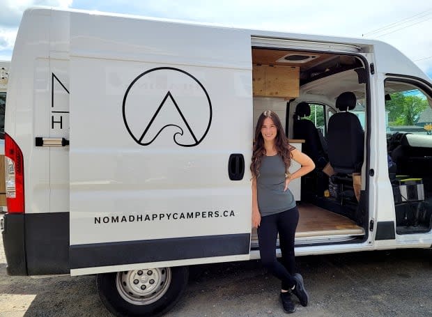 Jacquie Heading stands with her first camper van, Disco. (Brittany Wentzell/CBC - image credit)