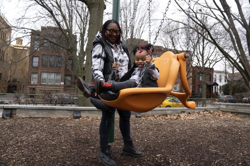 Chicago educator Tamisha Holifield spends time with her 2-year-old daughter Rian Holifield at Nichols Park, Thursday, Dec. 29, 2022, in the Hyde Park neighborhood of Chicago. When Holifield and her daughter had COVID-19 in May, the toddler had to miss 15 days of child care. Bouts of colds have followed in what Holifield described as a "constant whirlwind" of sickness that has been stressful both financially and emotionally. "It's a major inconvenience. But I'm a single parent, so I don't have a choice. If I drop the ball, the game is over," Holifield said. (AP Photo/Erin Hooley)