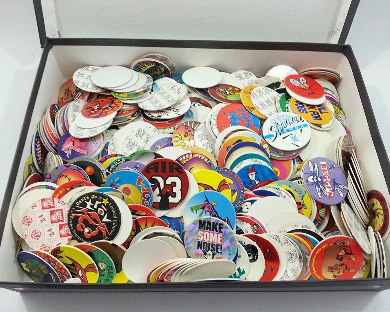 Assorted pogs in an open chest