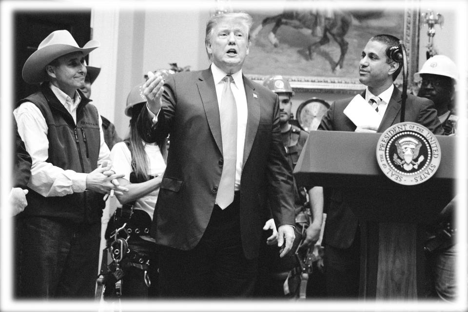 FCC chairman Ajit Pai, right, looks on as President Donald Trump delivers remarks on the deployment of 5G technology in the United States during an event in the Roosevelt Room of the White House, Friday, April 12, 2019, in Washington. (Photo: Evan Vucci/AP, digitally enhanced by Yahoo News)