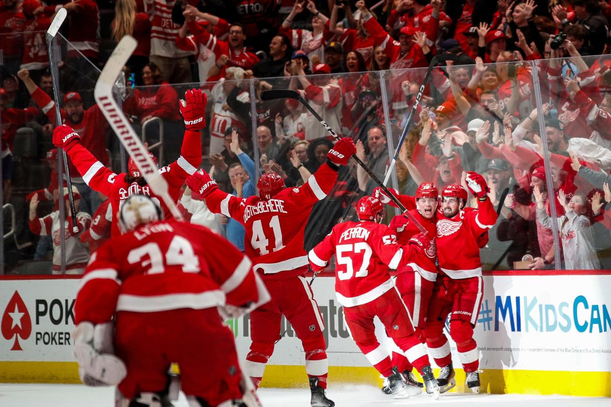 Detroit Red Wings players celebrate a goal scored by left wing Lucas Raymond (23) against Montreal Canadiens during overtime at Little Caesars Arena in Detroit on Monday, April 15, 2024.