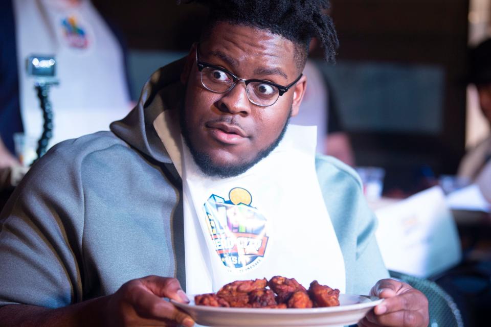 Trey Smith, offensive lineman for the University of Tennessee football team, participates in a wing-eating contest at Wild Wing Cafe on Feb. 10, 2020. Smith, who now plays in the NFL for the Kansas City Chiefs, was among multiple East Tennessee celebrities who participated in this Read City USA fundraising event, organized by Knox County Mayor Glenn Jacobs.