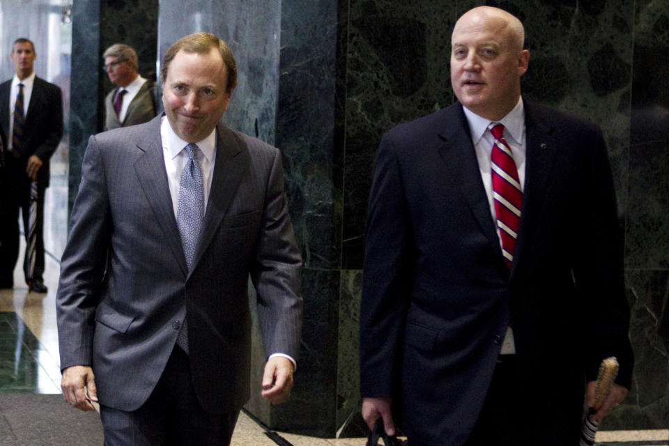 NHL Commissioner Gary Bettman, left, and Bill Daly, deputy commissioner and chief legal officer, make their way to speak with reporters following collective bargaining talks, Tuesday, Aug. 14, 2012, in Toronto. (AP Photo/The Canadian Press, Chris Young)