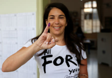 A woman shows her ink-stained finger after casting her vote during the parliamentary election in Beirut, Lebanon, May 6, 2018. REUTERS/Jamal Saidi